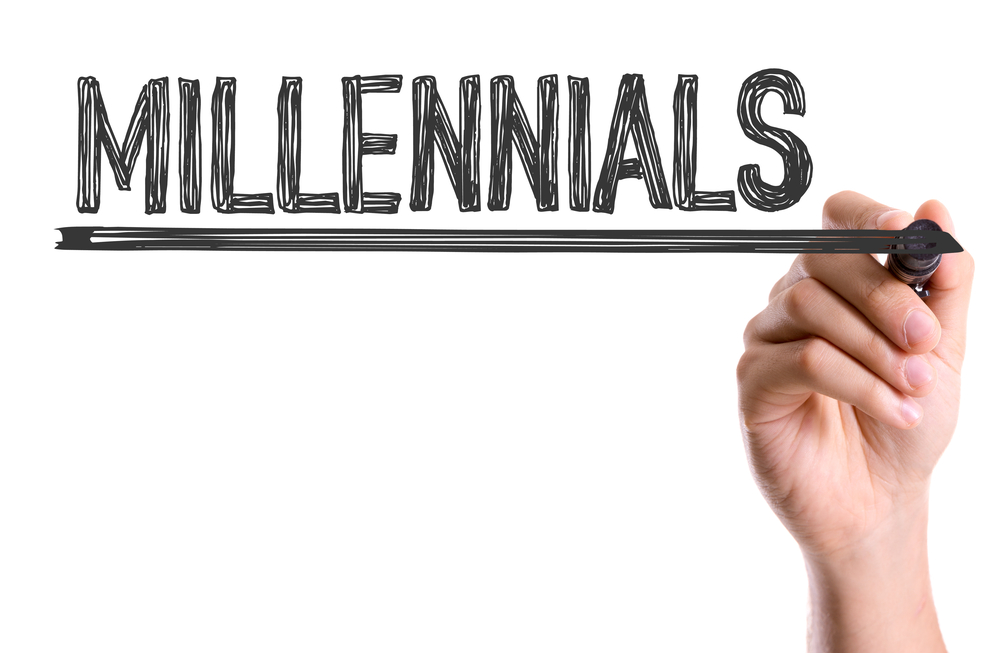 Hand with marker writing the word Millennials